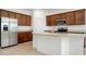 Spacious kitchen featuring granite countertops, stainless steel appliances, a center island, and wood cabinets at 24229 Spartina Dr, Venice, FL 34293