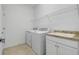 Laundry room featuring washer, dryer, sink and wire shelving at 24229 Spartina Dr, Venice, FL 34293