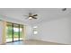 Bright living room view features sliding glass doors, neutral walls and ceiling fan at 24229 Spartina Dr, Venice, FL 34293