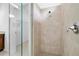 Bright shower featuring a seamless glass enclosure and tiled walls with a closet view at 24229 Spartina Dr, Venice, FL 34293