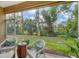 Enjoy the view from this screened porch with wicker furniture at 27231 Ipswich Dr, Englewood, FL 34223