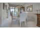 Dining area featuring white chairs around a glass table with an outdoor view at 302 Woodingham Ct, Venice, FL 34292