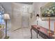 Inviting entryway with white tile floors, a decorative table, and a pendant light fixture at 302 Woodingham Ct, Venice, FL 34292