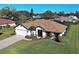 Charming one-story home boasts a well-manicured lawn, inviting entryway, and attached two-car garage at 302 Woodingham Ct, Venice, FL 34292