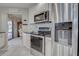 Charming kitchen featuring stainless steel appliances, updated countertops, and sleek backsplash at 302 Woodingham Ct, Venice, FL 34292