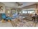 Comfortable living room with a ceiling fan, plush sofas, and a bright, airy atmosphere at 302 Woodingham Ct, Venice, FL 34292