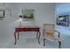 Hallway featuring a decorative table with drawers and a plush chair at 302 Woodingham Ct, Venice, FL 34292