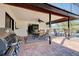 Covered patio featuring brick flooring, dining table, and view of the pool at 302 Woodingham Ct, Venice, FL 34292