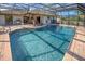 Screened pool with brick border, perfect for outdoor enjoyment and entertaining guests at 302 Woodingham Ct, Venice, FL 34292