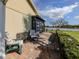 Backyard patio with chairs, enclosed lanai, and serene lake view at 3020 Sail Pointe Cir # 5A, Venice, FL 34293