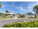 East Village Center with lush landscaping, American flag and clear blue skies at 3020 Sail Pointe Cir # 5A, Venice, FL 34293