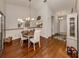 Cozy dining room featuring hardwood floors and a stylish chandelier over the round wood table at 3020 Sail Pointe Cir # 5A, Venice, FL 34293