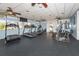 Well-lit gym features modern exercise equipment, including treadmills, stationary bikes, and ceiling fans for comfort at 3020 Sail Pointe Cir # 5A, Venice, FL 34293