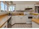 Well-lit kitchen featuring white appliances and cabinets, complete with a functional layout and ample counter space at 3020 Sail Pointe Cir # 5A, Venice, FL 34293