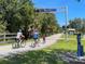 Cyclists enjoying a sunny day on the Legacy Trail, a scenic path surrounded by nature at 3020 Sail Pointe Cir # 5A, Venice, FL 34293