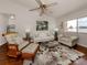 Cozy living room featuring wood floors, floral area rug, and water view at 3020 Sail Pointe Cir # 5A, Venice, FL 34293