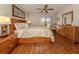 Light filled main bedroom with wood floors and sliding glass door leading to outdoor patio at 3020 Sail Pointe Cir # 5A, Venice, FL 34293