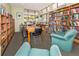 Inviting reading room offers a quiet place to study, featuring tables, chairs, and shelves full of books at 3020 Sail Pointe Cir # 5A, Venice, FL 34293