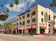 Exterior view of a historic shopping mall with retail stores, restaurants, and palm trees lining the street at 3020 Sail Pointe Cir # 5A, Venice, FL 34293