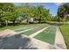 Multiple outdoor shuffleboard courts offer a fun and engaging activity for residents in a green and sunny environment at 3020 Sail Pointe Cir # 5A, Venice, FL 34293