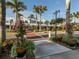 Picturesque street view with shops, lush landscaping, and palm trees, creating a welcoming and attractive atmosphere at 3020 Sail Pointe Cir # 5A, Venice, FL 34293