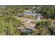 This aerial view shows a cozy home with a screened in pool amid lush greenery at 3415 N Cranberry Blvd, North Port, FL 34286