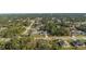 Aerial view of homes in a residential community surrounded by many trees at 3415 N Cranberry Blvd, North Port, FL 34286