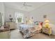 Bright bedroom with ceiling fan, window, and floral bedding at 3415 N Cranberry Blvd, North Port, FL 34286