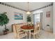 Dining room with wooden table, six chairs, and decorative wallpaper border at 3415 N Cranberry Blvd, North Port, FL 34286