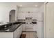 Kitchen featuring white appliances, dark countertop and white cabinets at 3415 N Cranberry Blvd, North Port, FL 34286