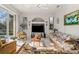 Bright living room with white tile floors, entertainment center, and sliding glass door to the pool at 3415 N Cranberry Blvd, North Port, FL 34286