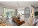 Bright living room with tile floors, striped furniture, and view of the pool at 3415 N Cranberry Blvd, North Port, FL 34286