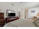 Comfortable main bedroom featuring a dresser, a TV and access to an en-suite bathroom at 3415 N Cranberry Blvd, North Port, FL 34286