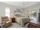 Main bedroom featuring neutral decor, a ceiling fan, a slider to the pool, and a sitting area at 3415 N Cranberry Blvd, North Port, FL 34286