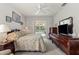 Comfortable main bedroom with carpet, ceiling fan, sliders to the pool, and dark wood furniture at 3415 N Cranberry Blvd, North Port, FL 34286