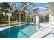 Inviting backyard pool area with a screened enclosure and sun-drenched patio for relaxation at 3415 N Cranberry Blvd, North Port, FL 34286