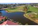 Aerial view of condos overlooking golf course and pond at 3500 El Conquistador Pkwy # 333, Bradenton, FL 34210