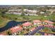 Aerial view of a condo community next to the golf course and pond at 3500 El Conquistador Pkwy # 333, Bradenton, FL 34210