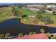 Aerial view of condos beside golf course, ponds, and trees at 3500 El Conquistador Pkwy # 333, Bradenton, FL 34210