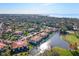 Aerial view of condo community overlooking a pond, trees and golf course at 3500 El Conquistador Pkwy # 333, Bradenton, FL 34210