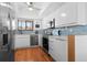 Well-lit kitchen featuring stainless steel appliances, modern white cabinetry and a mosaic tile backsplash at 3500 El Conquistador Pkwy # 333, Bradenton, FL 34210