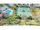 Aerial view of the tennis courts, pool and a playground surrounded by mature trees and manicured landscaping at 3730 82Nd Avenue E Cir # 104, Sarasota, FL 34243