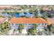 Aerial view of townhomes and a lake in a neighborhood lined with trees and greenery at 3730 82Nd Avenue E Cir # 104, Sarasota, FL 34243