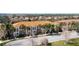 A serene residential area featuring elegant townhomes with terracotta roofs amidst lush greenery and well-maintained landscaping at 3730 82Nd Avenue E Cir # 104, Sarasota, FL 34243