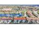 A beautiful aerial view of townhomes with red tile roofs situated around a scenic lake and lush landscaping at 3730 82Nd Avenue E Cir # 104, Sarasota, FL 34243