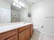 Bathroom featuring a wood vanity with large mirror, toilet, and tub-shower combo at 3730 82Nd Avenue E Cir # 104, Sarasota, FL 34243