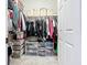 Walk-in closet with ample shelving and hanging space for organized storage at 3730 82Nd Avenue E Cir # 104, Sarasota, FL 34243