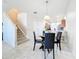 Dining area adjacent to the kitchen and stairs, filled with natural light and tile flooring at 3730 82Nd Avenue E Cir # 104, Sarasota, FL 34243