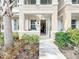 Inviting front entrance with an open doorway, decorative plants, and a glimpse of the home's interior at 3730 82Nd Avenue E Cir # 104, Sarasota, FL 34243