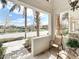 Cozy front porch with outdoor seating overlooking the scenic street and pond at 3730 82Nd Avenue E Cir # 104, Sarasota, FL 34243